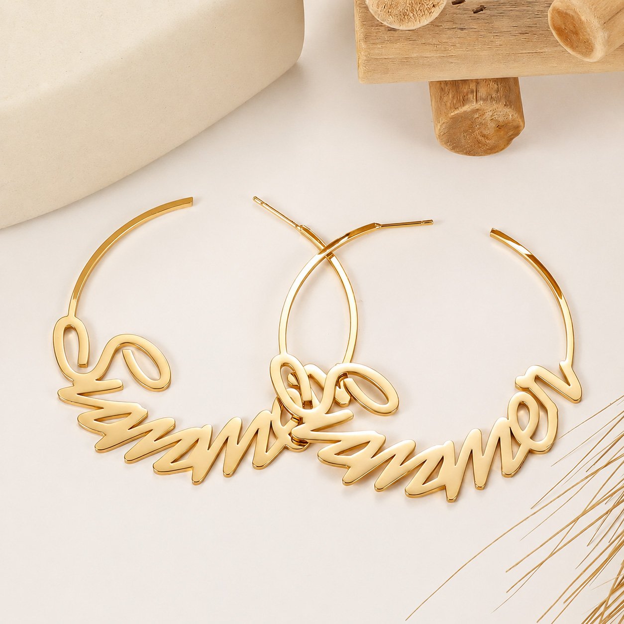 Gold Custom Name Hoop Earrings featuring a personalized cursive name design in an elegant neutral setting