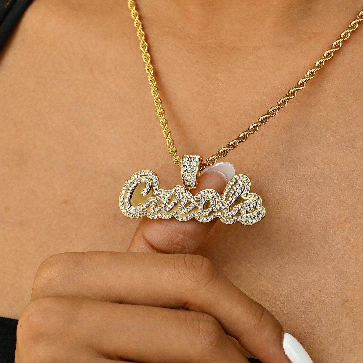 Crystal Cursive Name Necklace in gold with sparkling crystal details and a rope chain, featuring a personalized cursive name pendant modeled on the neckline