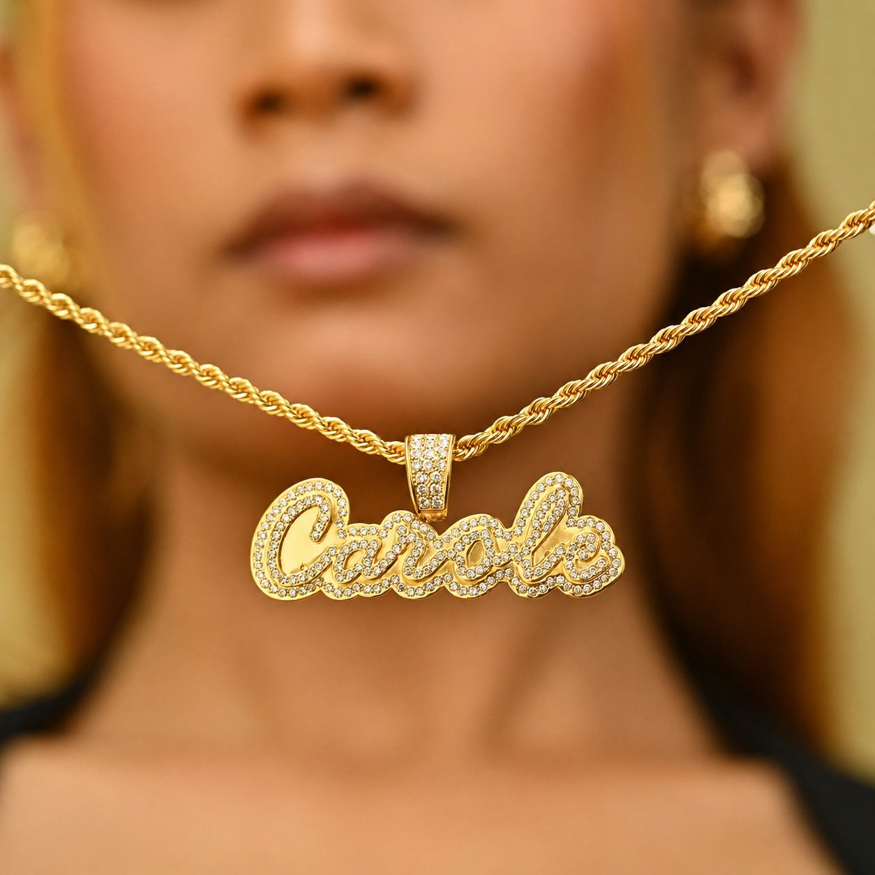 Gold Crystal Cursive Name Necklace with a sparkling custom name pendant and rope chain, shown close-up on a model