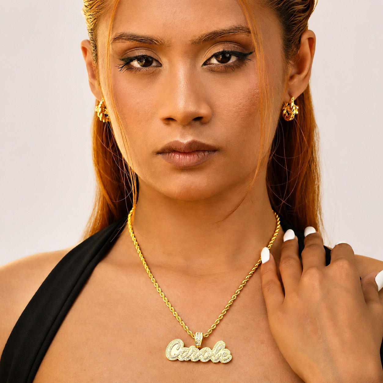 Model wearing a gold Crystal Cursive Name Necklace with a sparkling custom name pendant and rope chain